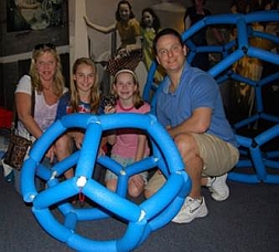 Family of visitors having just completed the C20 Buckyball challenge. Giant C60 Buckyball in background.